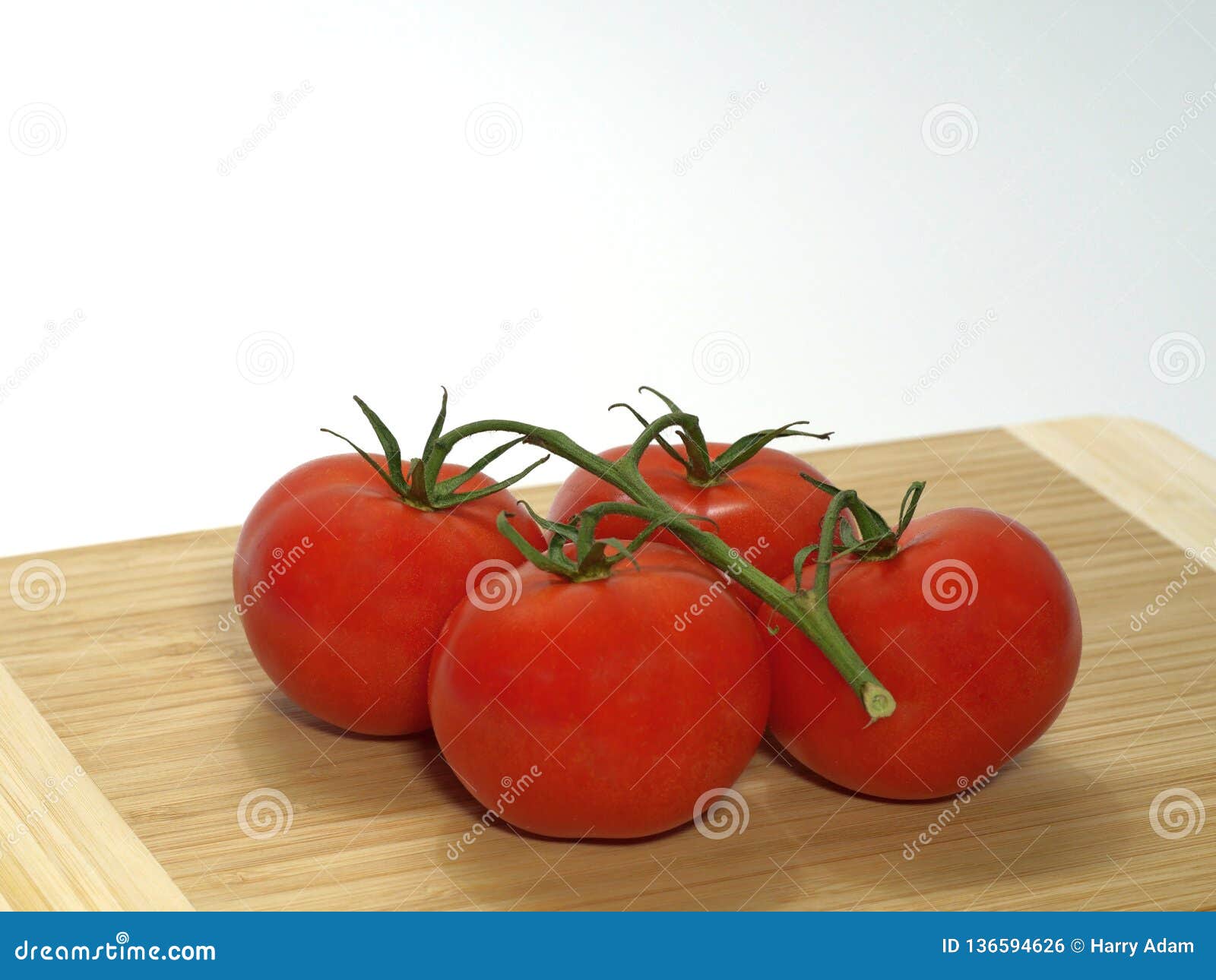 tomatoes shrub stems large wooden board against white background 136594626